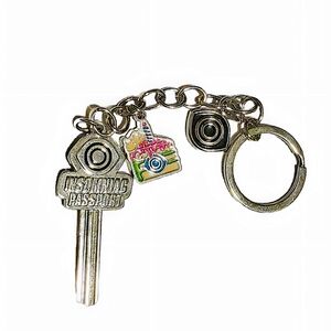 NWOT EDC Insomniac Passport Collectable Key with cake and eye charms